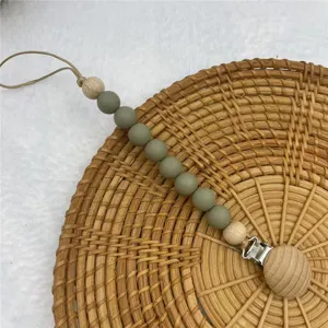 Silicone wooden pacifier clip detail view, featuring safe teeth beads for infant daily use.