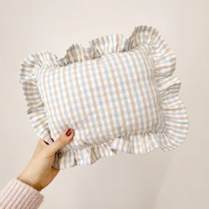 Nordic style ramie soothing pillow with ruffled edge and gingham pattern for baby bedroom decor.