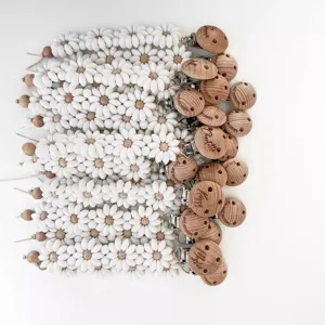 Silicone daisy flower pacifier clip set with personalized engraved wooden beads for babies.