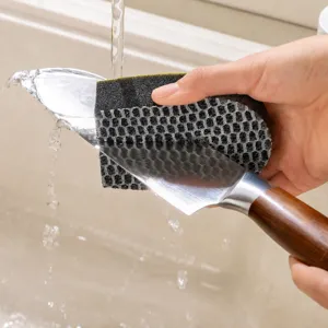 Double-sided sponge brush with U-shaped groove design for safe kitchen knife cleaning.