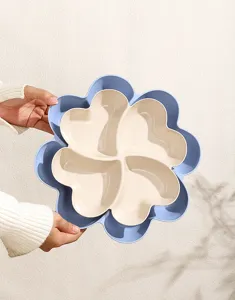 Detail shot of the blue and beige flower shaped multi grid snack storage fruit tray.