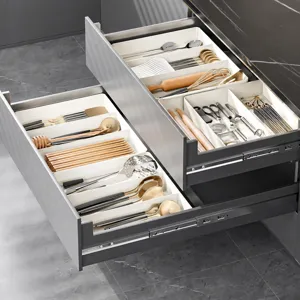 Kitchen drawer organizer detail showing adjustable compartments and tidy tableware storage.