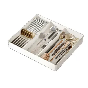 Retractable kitchen drawer organizer box with multiple compartments for tableware storage.