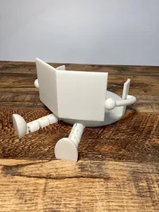 Vue de détail en gros plan d'un support de mouchoir robot blanc imprimé en 3D sur table.