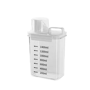 Transparent laundry detergent storage container with measuring cup and scale lines for home use.