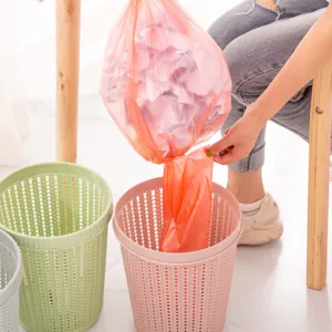 Modern plastic hollow trash can with automatic bag dispenser for home kitchen and bathroom.