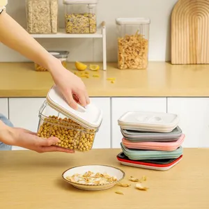 Square transparent kitchen storage jar for grains, airtight food container with lid and spoon.