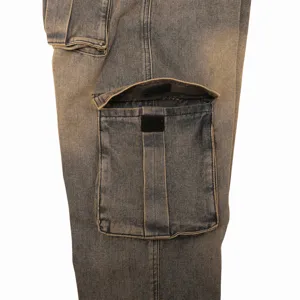 Detailed view of men's distressed cargo denim jeans showing multi-pocket design and stitching.