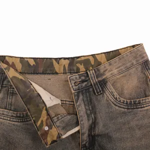 Closeup of men's vintage washed denim cargo jeans waist with camo inner lining detail.