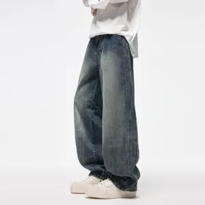 Vintage washed distressed curved denim jeans for men and women, loose fit wide leg pants.