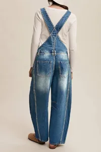 Close-up back view of casual denim overalls featuring adjustable straps and pockets.