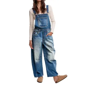 Close-up details of vintage wash denim overalls featuring multiple pockets and loose wide-leg fit.