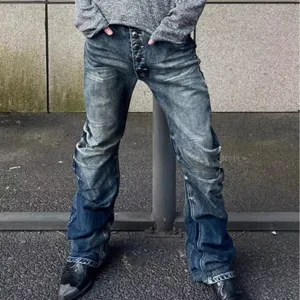 Details of men's vintage washed stacked flared jeans featuring unique pleats and button fly.