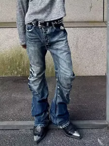 Men's street style washed blue stacked flare denim jeans featuring button fly and pleats.