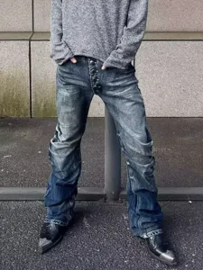 Detailed shot of men's blue stacked flared jeans with vintage wash and unique button fly design.