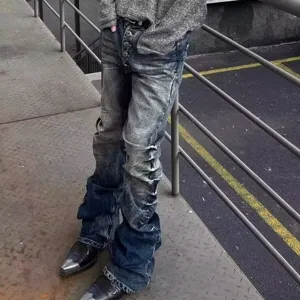 Detail view of men street style stacked flare jeans in acid blue wash with button fly.