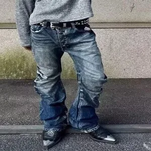 Detailed shot of men's stacked flare denim jeans with unique wash and button fly design.