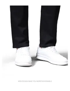 Men's casual black trousers and white sneakers detail view showcasing fashion style.