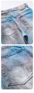 Blue gradient denim shorts close-up view showing back pocket and leather patch details.