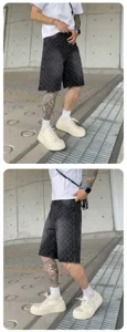American high street washed printed men's denim shorts, distressed black casual streetwear.