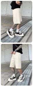 Men casual streetwear shorts and stylish chunky sneakers detail view showcasing trendy design.