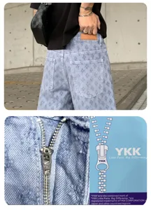 Detail view of American high street washed printed men denim shorts with YKK zipper hardware.