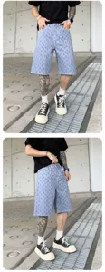 Detailed view of men's washed printed denim shorts featuring urban streetwear style.