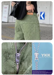 Close-up details of the distressed washed denim shorts featuring YKK zipper and back leather label.