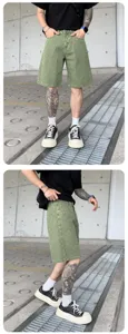 Detailed view of men washed green denim shorts, street style distressed design, urban fashion apparel.