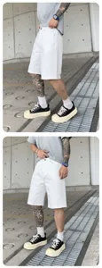 Men's white washed denim shorts detailed view, casual streetwear style, comfortable fit.