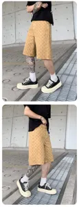Men's washed printed streetwear shorts detail view, featuring casual loose fit and stylish pattern.