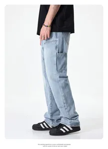 Detailed view of men light blue loose straight jeans with side pockets and stylish street wear.
