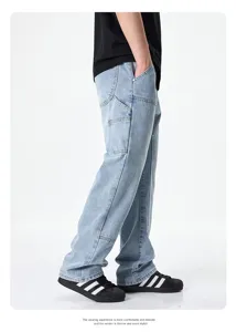 Detailed side view of loose fit blue denim carpenter jeans with spacious pockets and straight leg.
