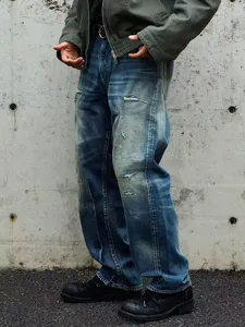 Distressed retro denim jeans detail view, loose straight fit, washed dirty street style pants.