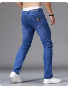 Men's classic slim fit tapered blue denim jeans detail view, premium casual style pants.
