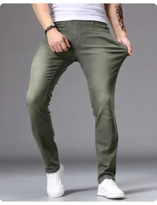 Detail view of men's slim-fit stretch denim jeans in military green, showing flexible fabric.