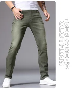 Detail view of men's slim fit green denim jeans showing fabric texture and leg fit.
