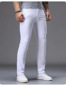 Detail view of men's white slim-fit jeans, comfortable stretch denim, stylish look.