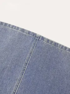 Blue denim skirt fabric detail close-up, showing classic texture and neat fine stitch.
