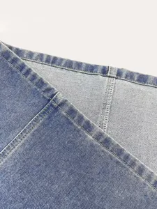Detailed shot of women's light blue non-stretch denim skirt showing fine stitching texture.