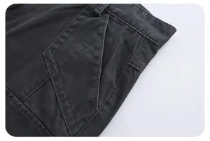 Dark grey washed cargo denim pants pocket detail shot showing fine stitching and durable fabric.