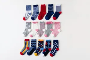Detailed view of colorful children cotton socks assortment with various patterns and ruffles.