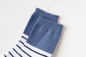 Close-up detail of children's blue and white striped cotton socks with ribbed cuff.