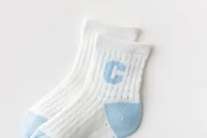 Detailed close-up view of breathable mesh children socks featuring letter pattern and soft texture.