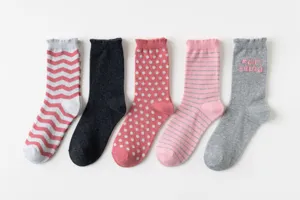 Detailed shot of trendy women mid-calf cotton socks set featuring multi patterns and pink colors.