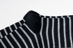 Close-up detail of black and grey striped cotton socks showing fine knit texture and heel.