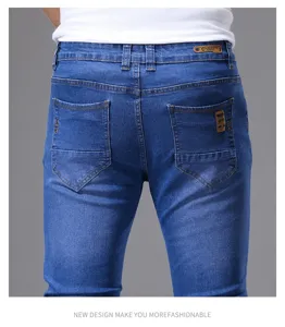 Back detail view of men's slim fit stretch denim jeans in classic blue wash with leather patches.