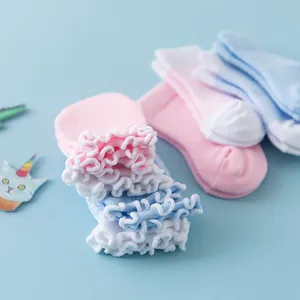 Infant cotton socks and anti-scratch mittens detail view with cute ruffle lace trim.
