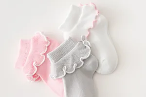 Children socks detail view, soft cotton ruffles design, breathable and comfortable texture.