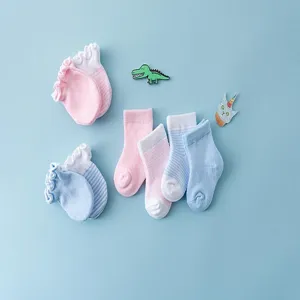 Detailed view of soft cotton baby socks and anti-scratch mittens set in blue and pink.